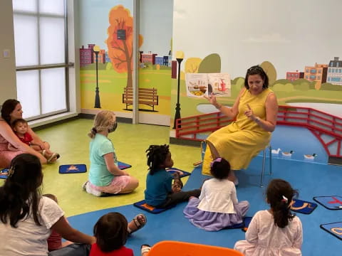 a woman teaching children in a classroom