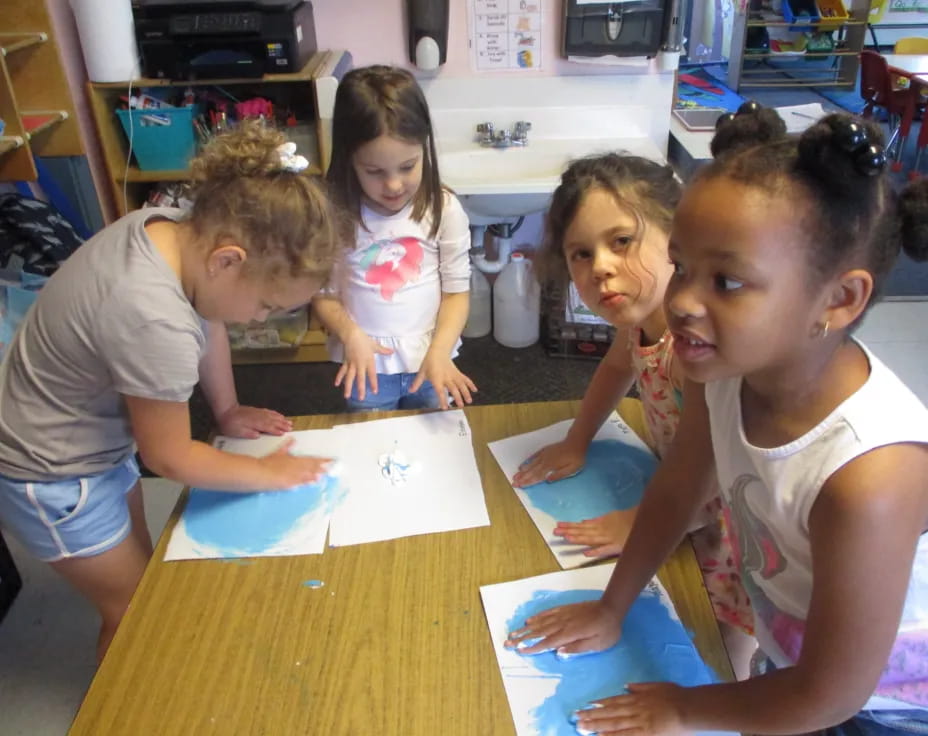 a group of children sitting at a table