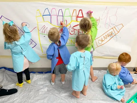 children drawing on a wall