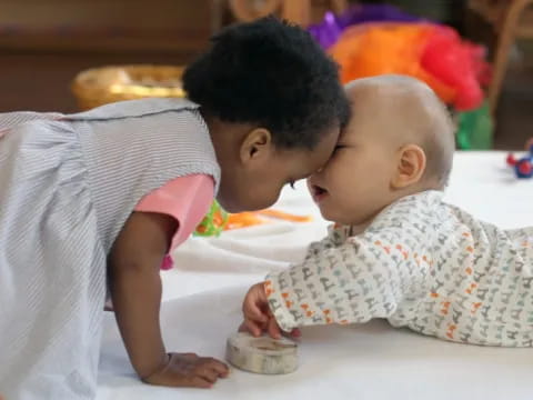 a baby kissing a baby