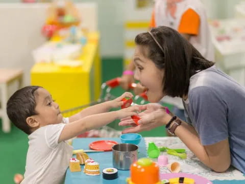 a person and a child playing with toys