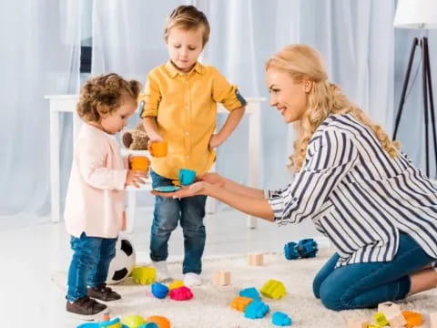 a person and two children playing with toys