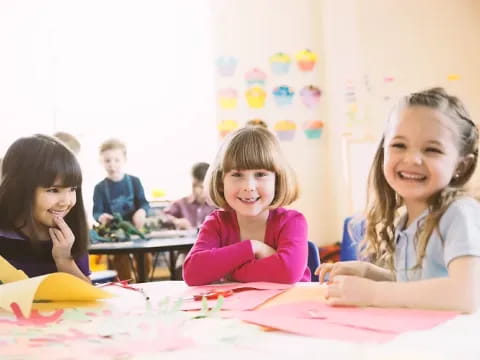 a group of children sitting at a table