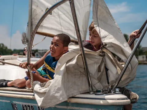 a man and a woman on a sailboat