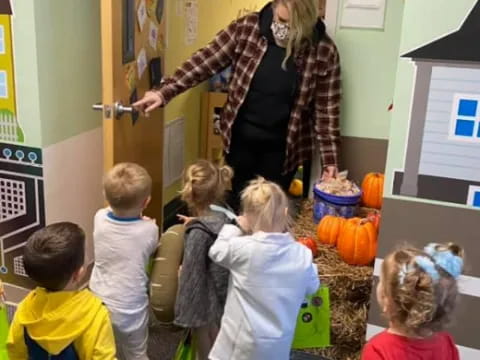 a person and children in a classroom