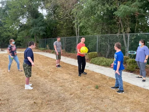 a group of people playing with a ball