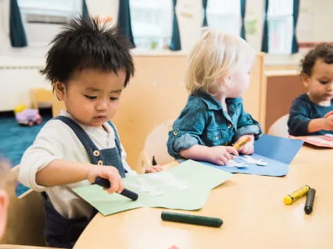 a few children sitting at a table