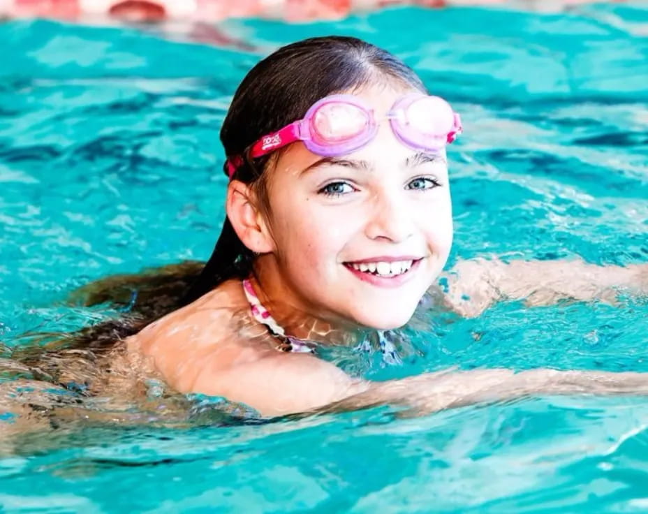 a girl swimming in a pool