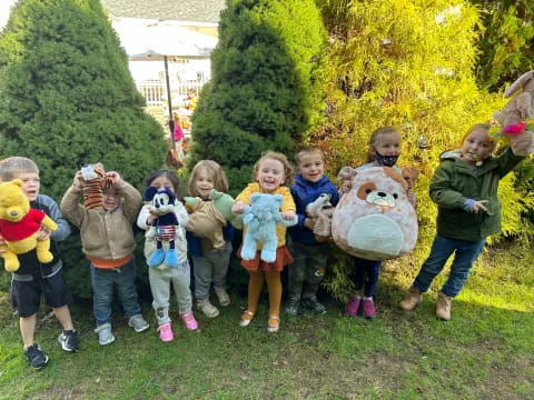 a group of children holding stuffed animals