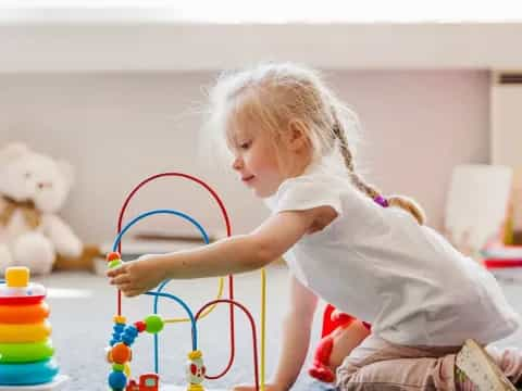 a little girl playing with a toy