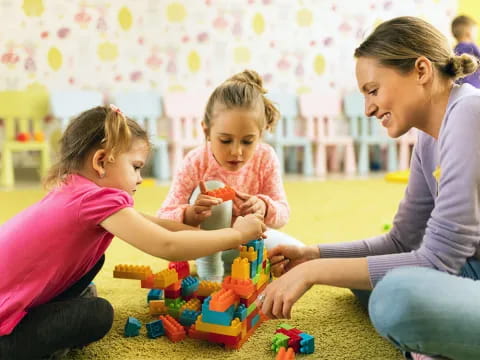 a woman and two children playing with toys