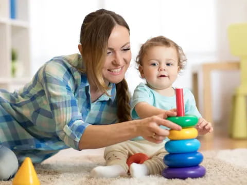 a person and a child playing with toys