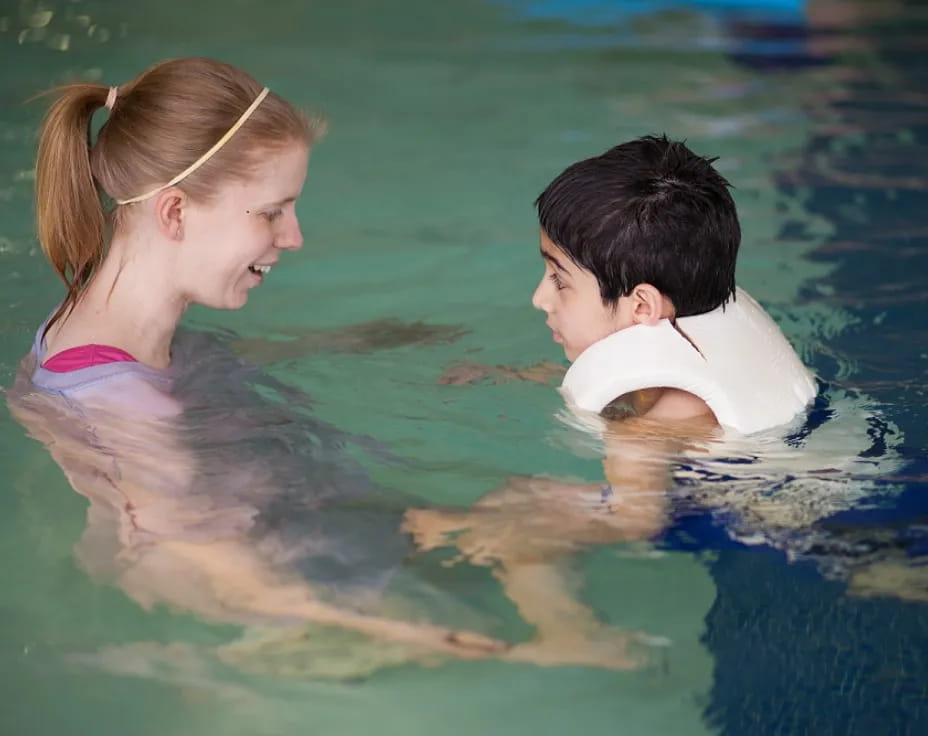 a boy and girl in a pool