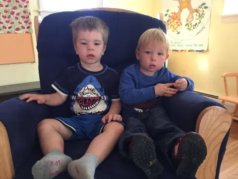 two boys sitting on a couch