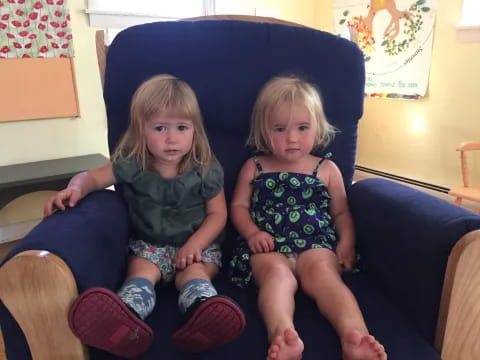 two girls sitting on a couch