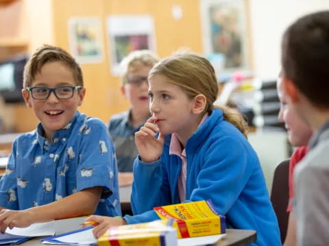 a group of children sitting at a table