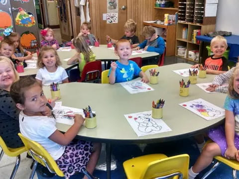 a group of children sitting at a table