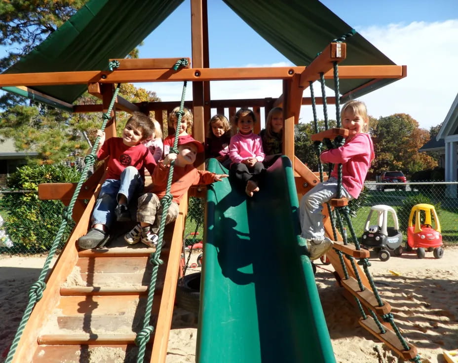 a group of children on a swing