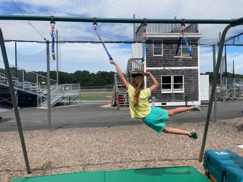 a girl swinging on a swing