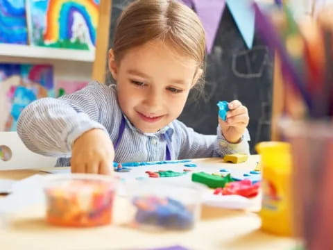 a child painting on a table