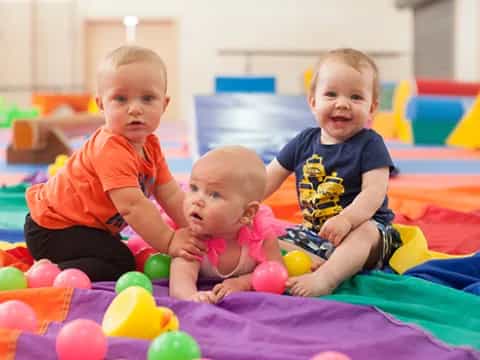 a group of babies playing in a ball pit