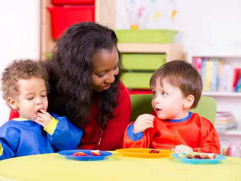 a person and two children eating