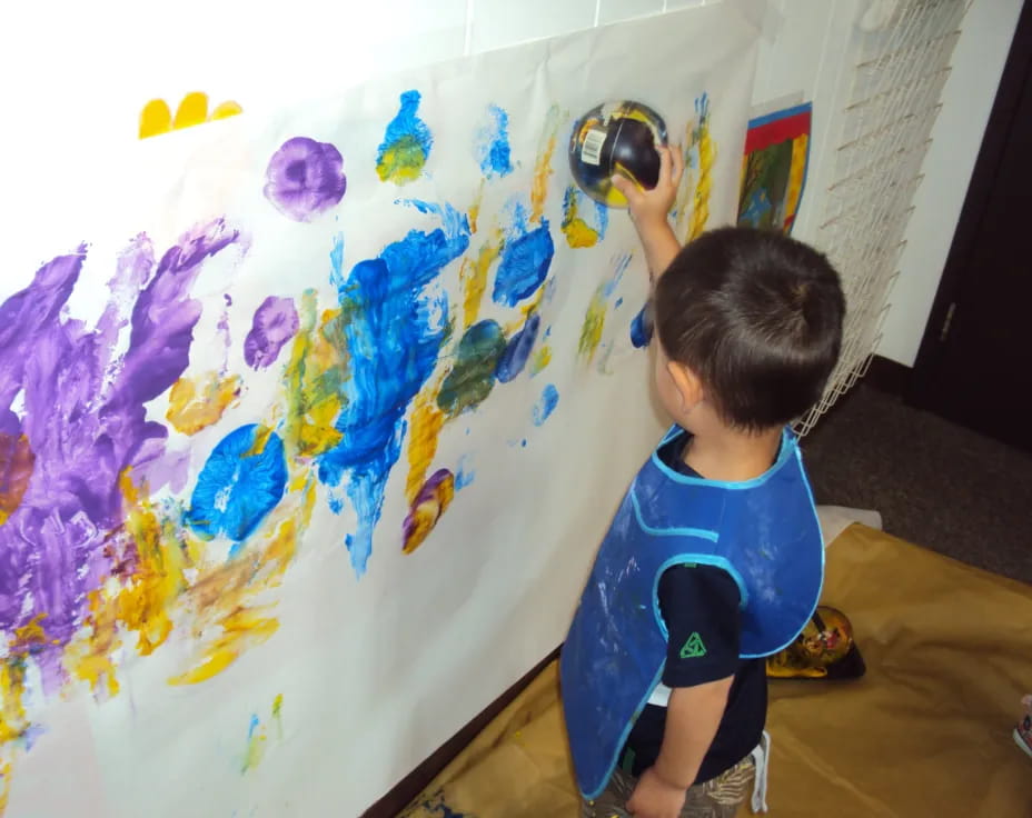 a child painting on a wall