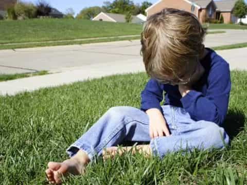 a child sitting in the grass