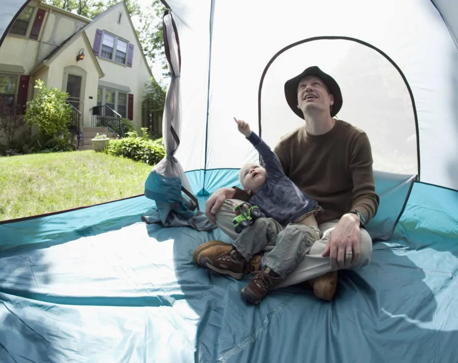 a man and a baby on a trampoline