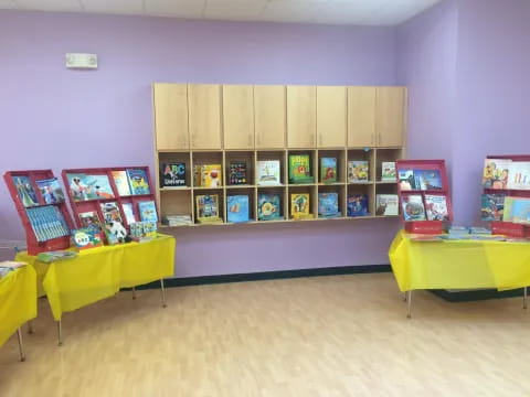 a room with a table and shelves