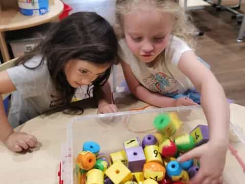 a couple of girls playing with balls