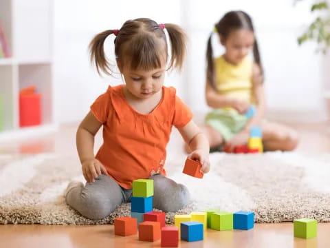 a young girl playing with blocks