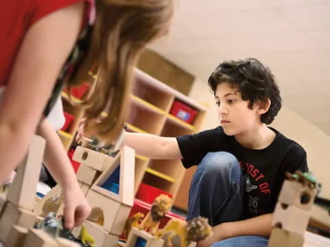 a person and a boy playing with toys