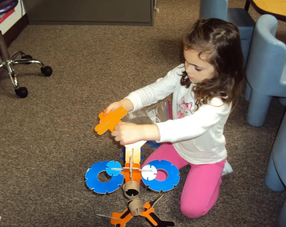 a girl playing with a toy