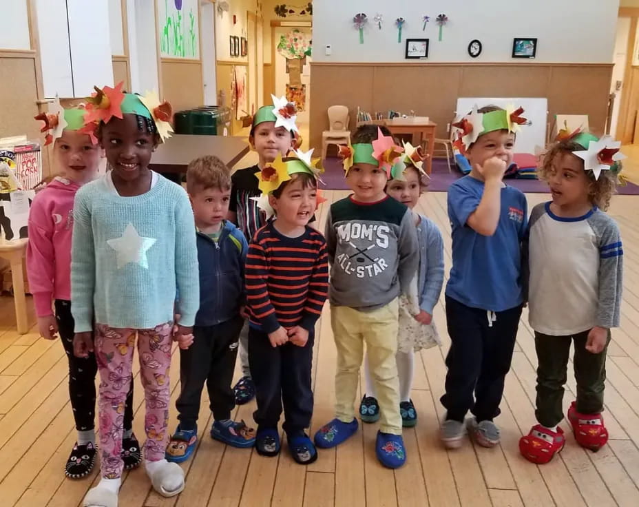 a group of children wearing party hats