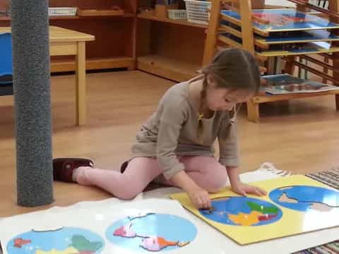 a child playing on a colorful floor