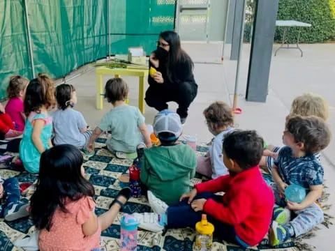 a group of children sitting on the floor playing with toys