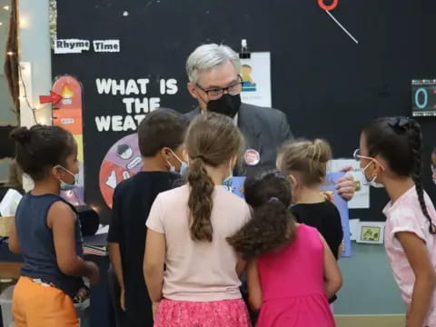 a person talking to a group of children