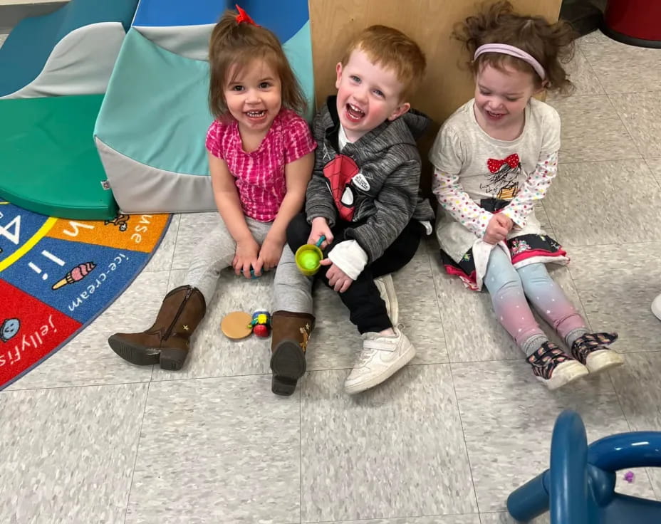 a group of children sitting on the ground