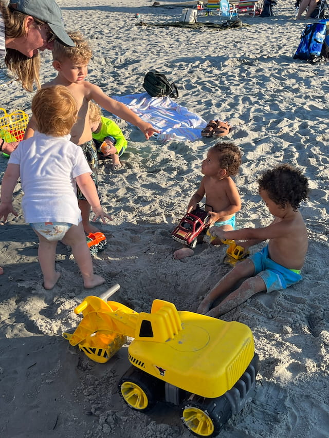 a group of children playing on the beach