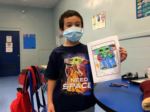 a boy holding a picture