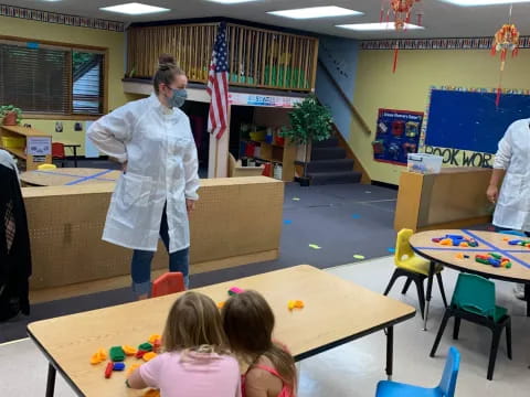 a person and children in a classroom