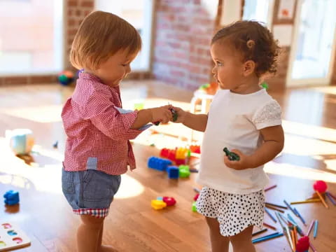 a couple of children playing with toys