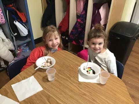 two girls sitting at a table