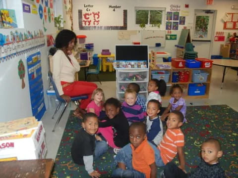 a person and a group of children in a classroom