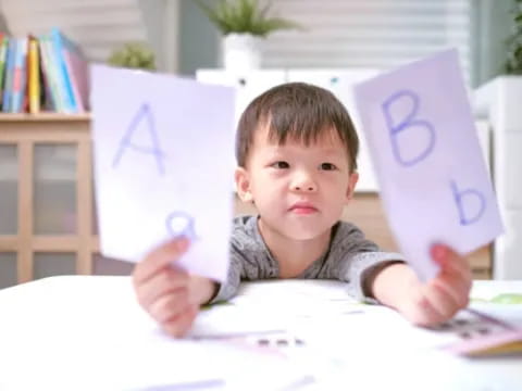 a boy holding a book