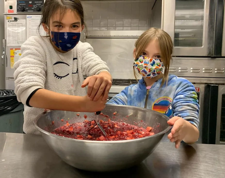 a couple of kids wearing masks and eating food