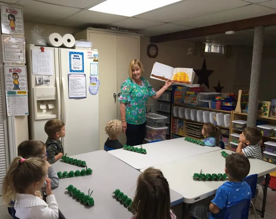 a person and children in a classroom