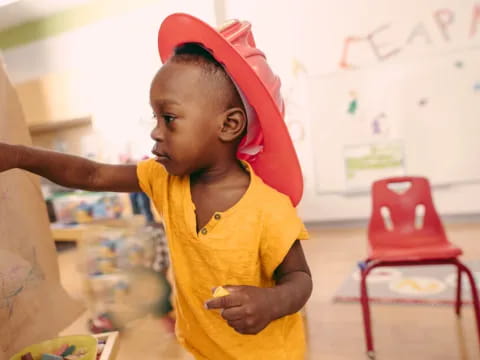 a child wearing a red hat