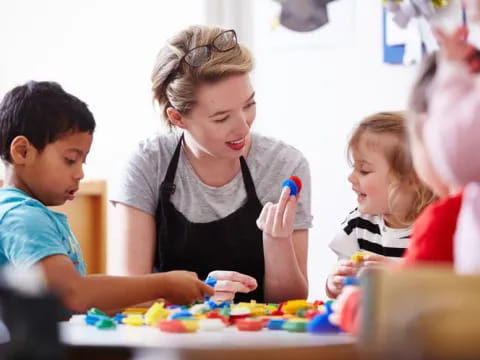 a person and children playing with toys